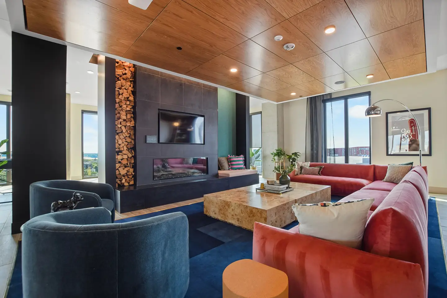 Apartment lounge with ample seating and a flat-screen TV.